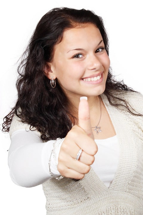 woman holding her thumb up whilst smiling