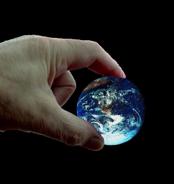 Hand holding earth representing manifestation technique